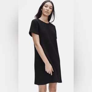 Eileen Fisher classic black shift dress. plush honeycomb texture. short sleeves.